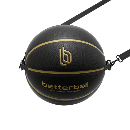 A black and gold colored basketball with the logo 'betterball' printed on it, equipped with a strap for resistance training.